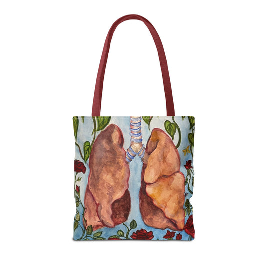 A tote bag with red handles and a printed design featuring a lungs and roses and vines