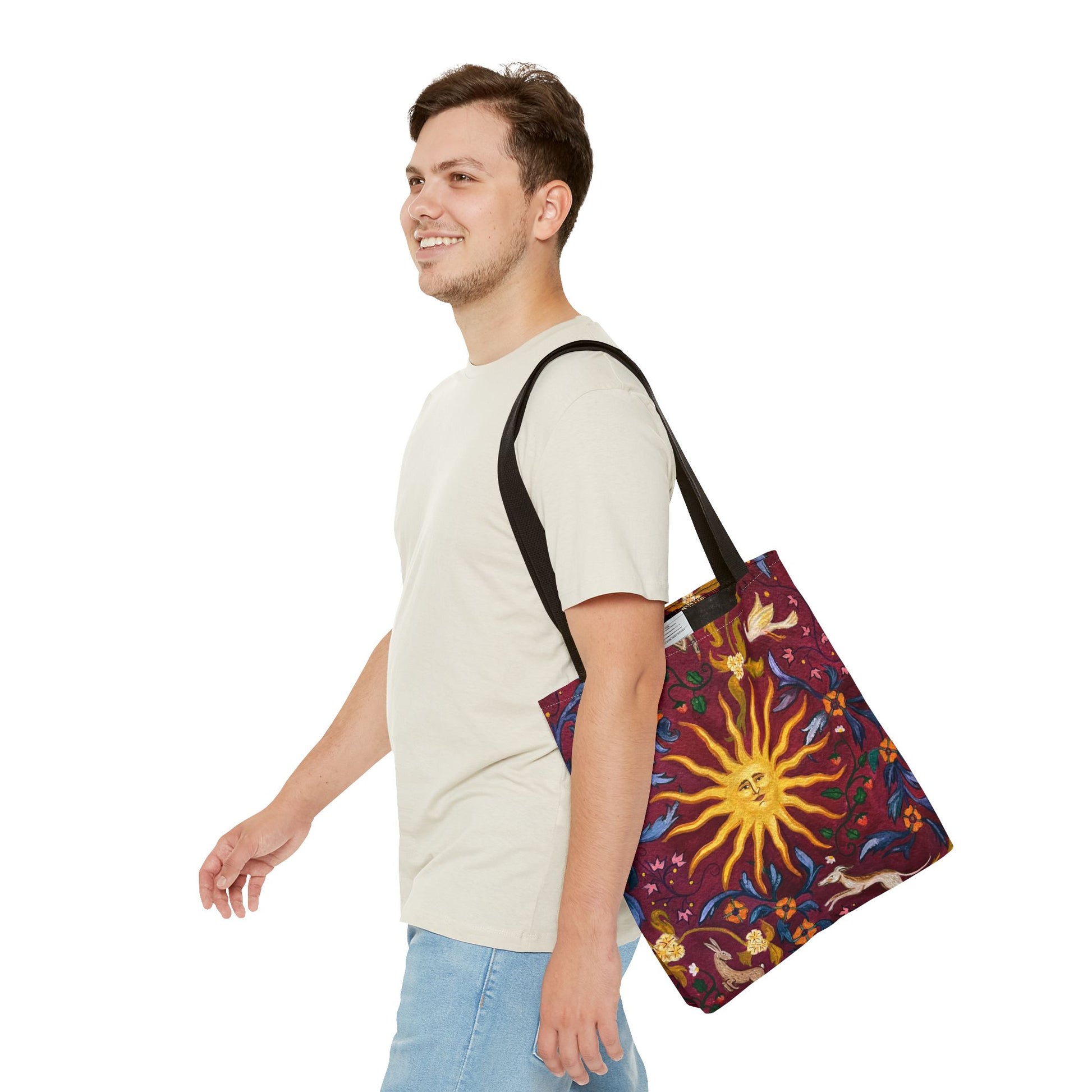 Man carrying a colorful tote bag with a sun design on a white background