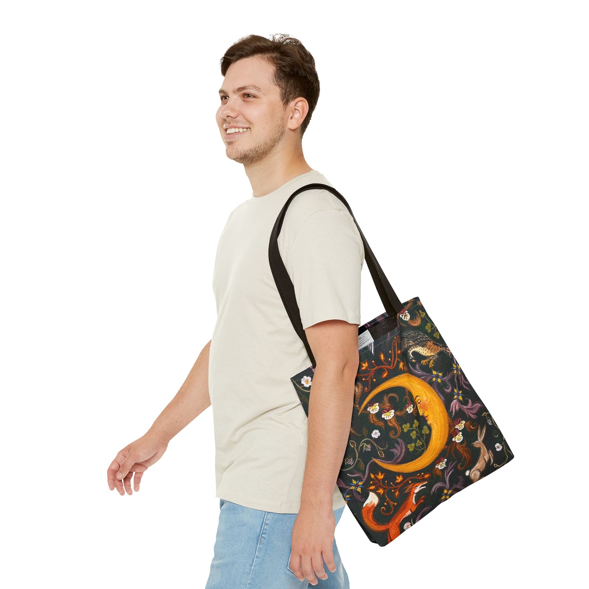 Man carrying a tote bag with a colorful design on a white background